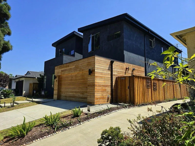 Finished dark limewash exterior with a cedar garage and fence in Santa Monica